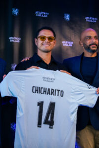 Chicharito holds his Dallas jersey